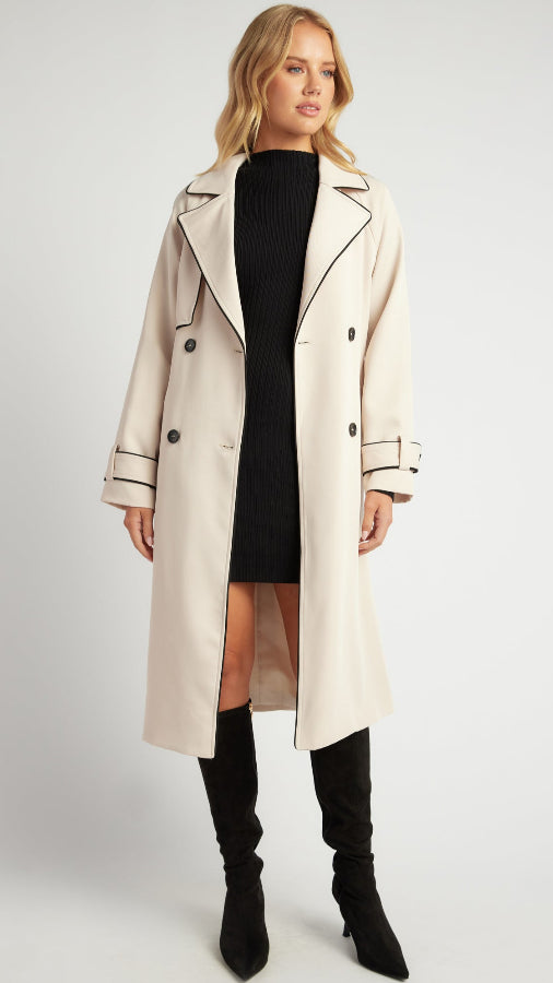 woman in a black knit dress,beige trench ,black boots