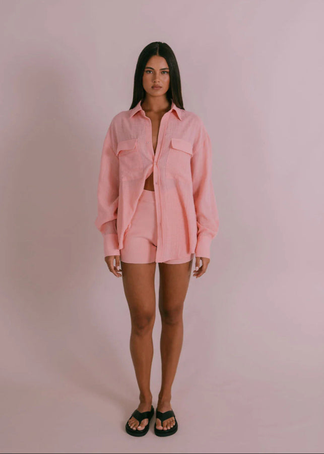 Model wearing Fairfax Shirt in pinky peach with oversized billowed sleeves and button cuffs from Vivian The Store