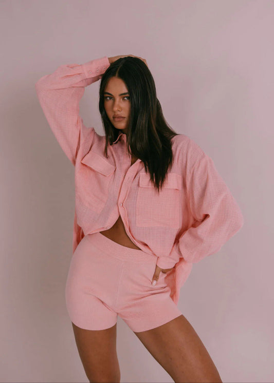 Model wearing Fairfax Shirt in pinky peach with oversized billowed sleeves and button cuffs from Vivian The Store