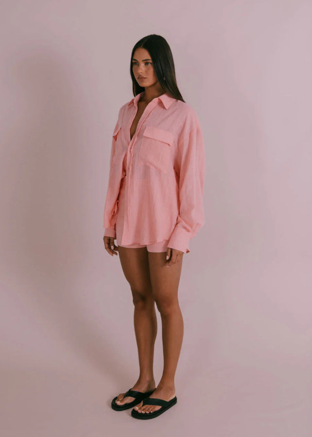 Model wearing Fairfax Shirt in pinky peach with oversized billowed sleeves and button cuffs from Vivian The Store